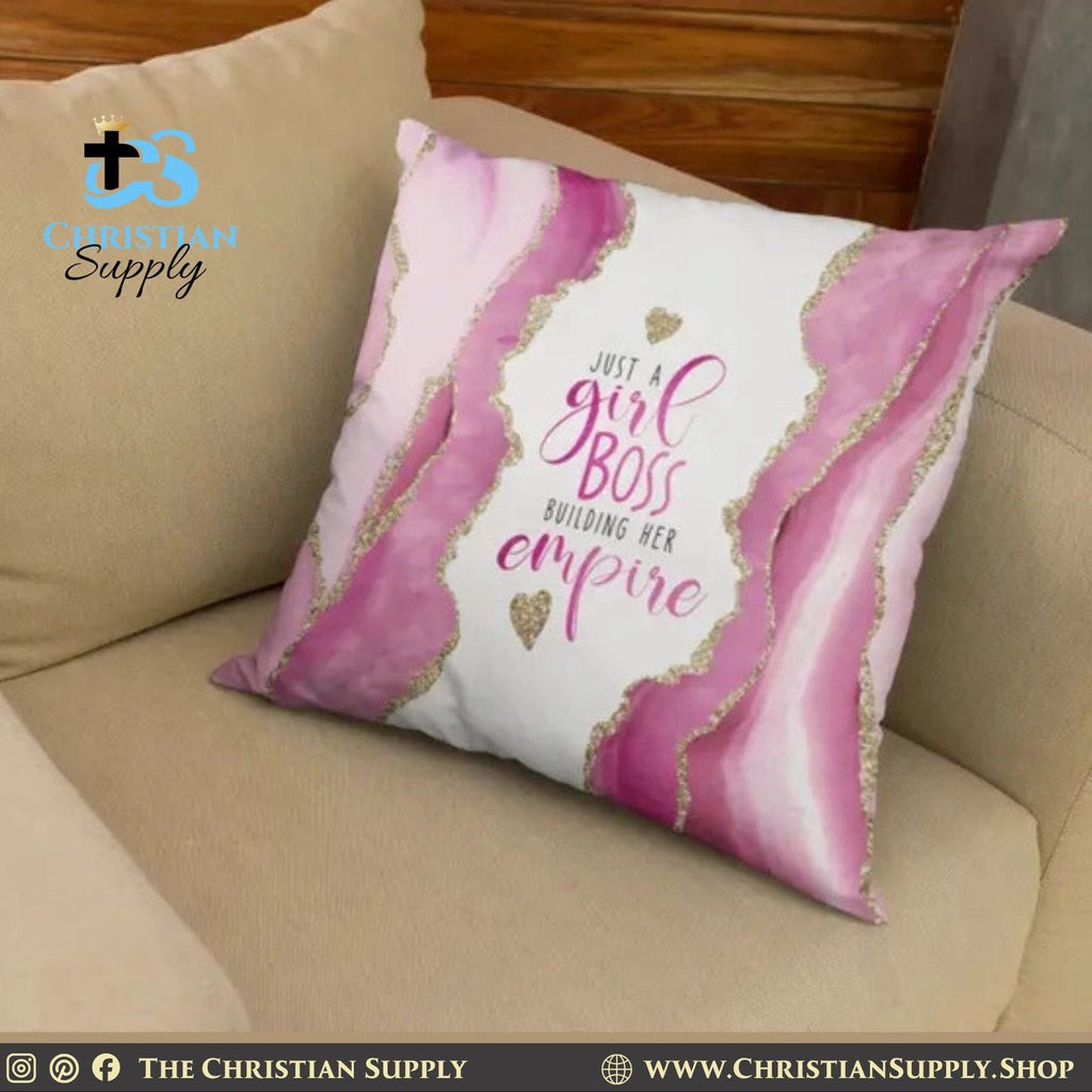 Decorative pillow with 'Just a girl boss building her empire' text on a beige couch.
